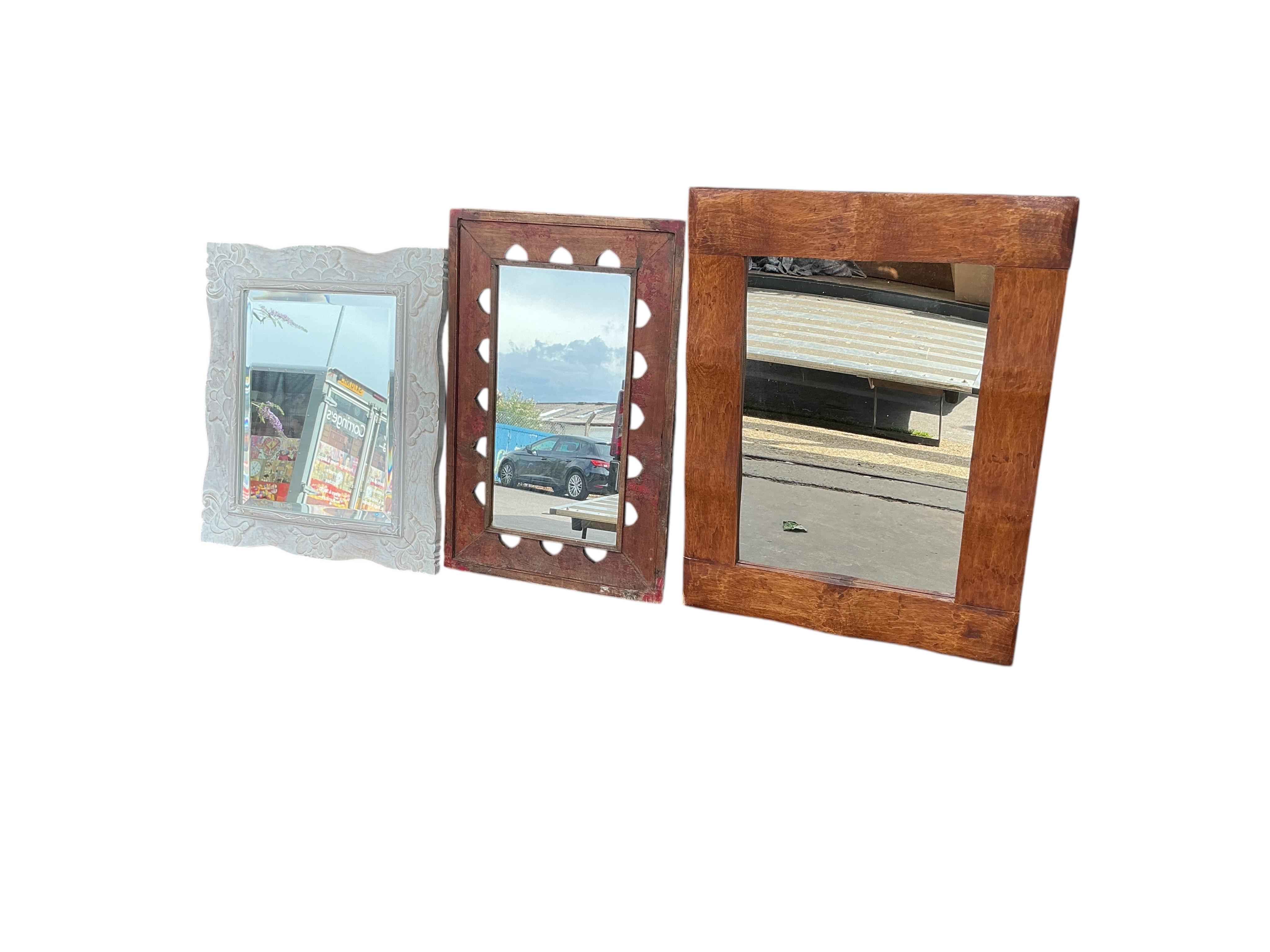Three modern wall mirrors, of which two with hardwood frames and one carved and painted white, largest width 64cm, height 84cm